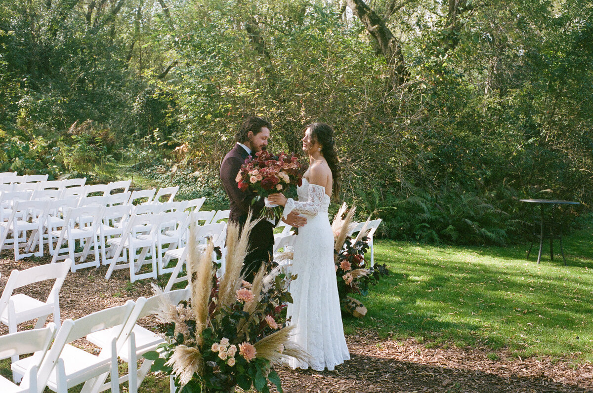bride and groom taking a moment before entering the reception hall and taking in the ceremony area 