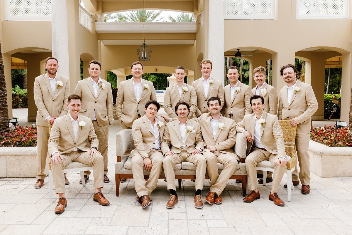 Stephen with his groomsmen in matching tan suits, celebrating at Cheeca Lodge.