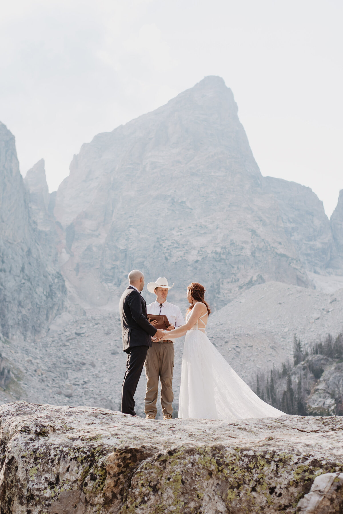 Jackson Hole photographers capture bride looking at officiant during ceremony