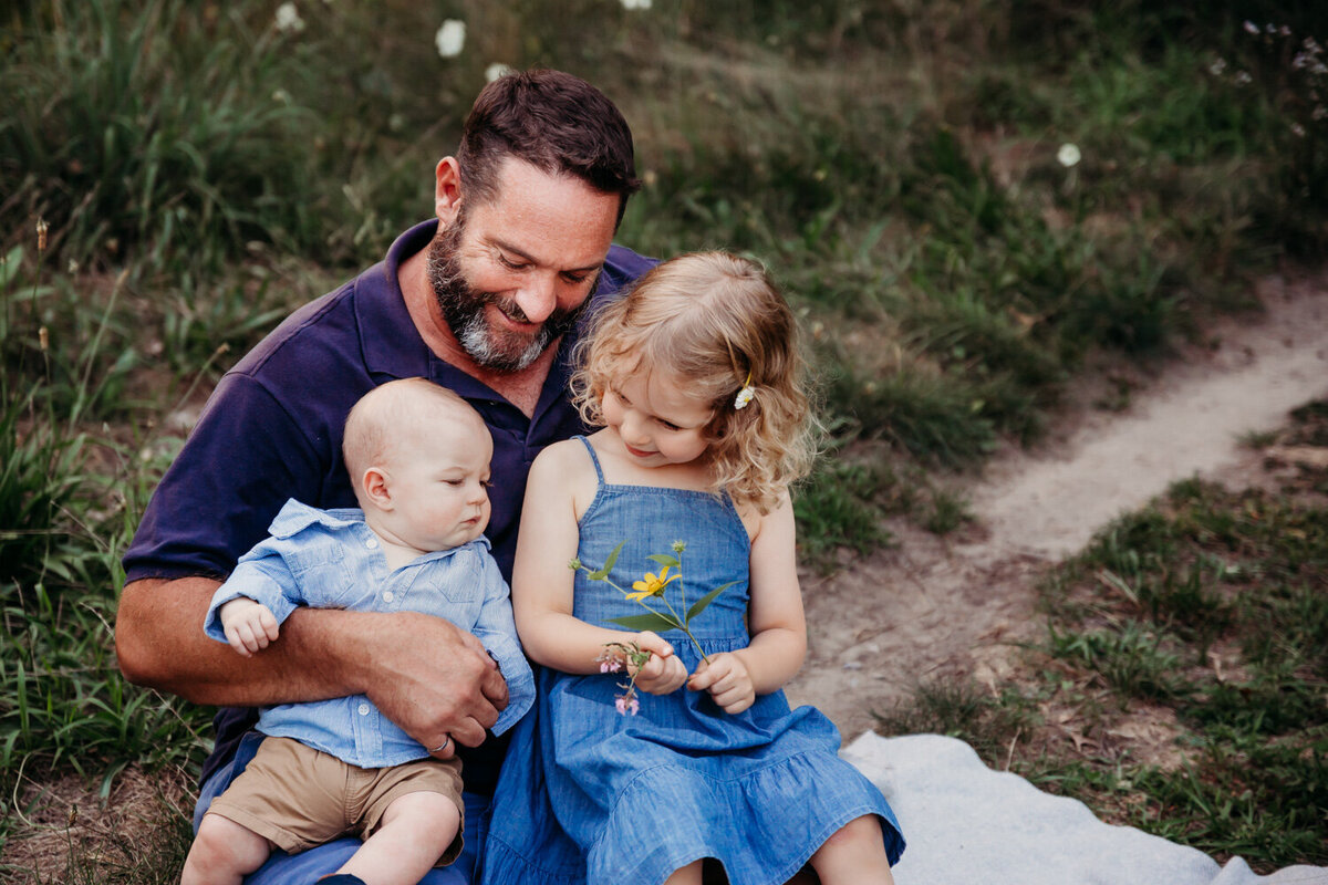 Father cuddling his two children during family portrait session by Claire Binks Photography