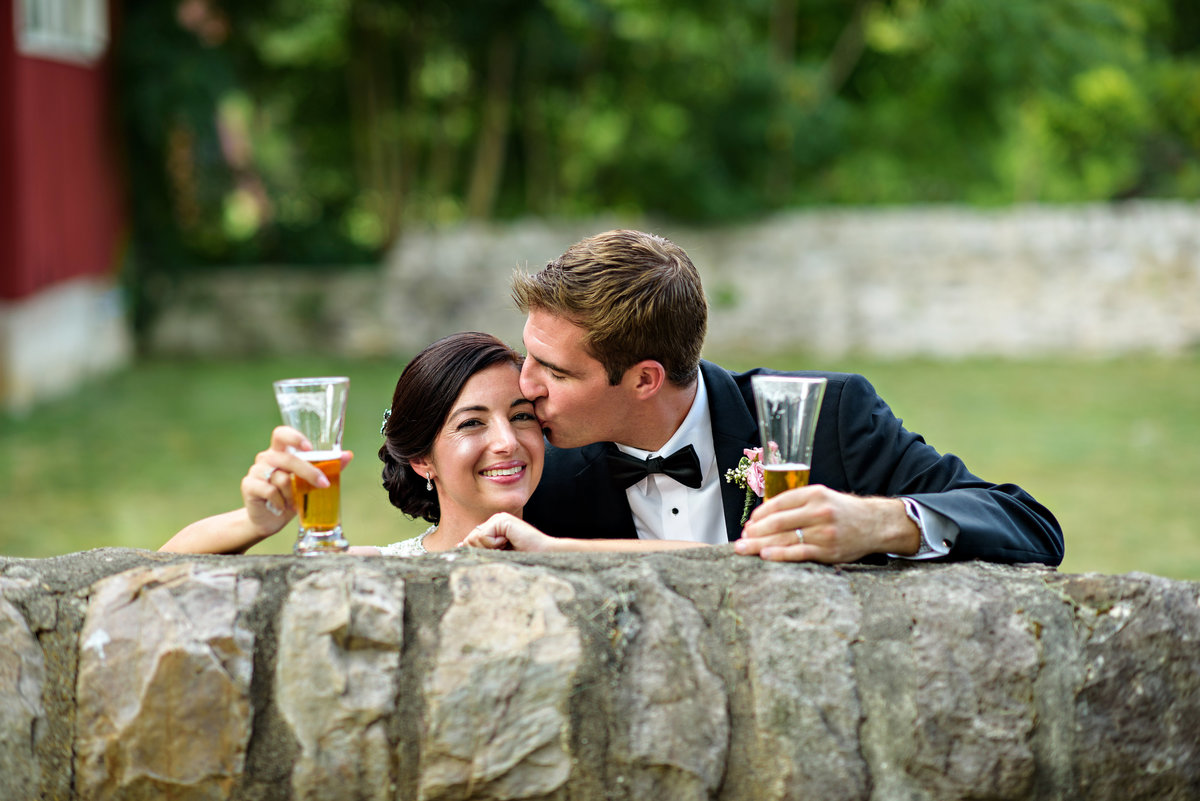 A newly married couple share a beer after the ceremony at The Manor House at Prophecy Creek.