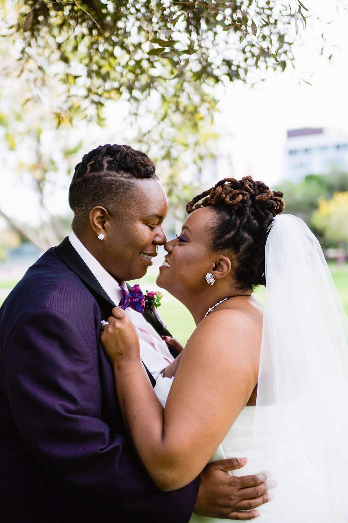 LGBTQ brides share a romantic moment on their wedding day by PMA Photography.