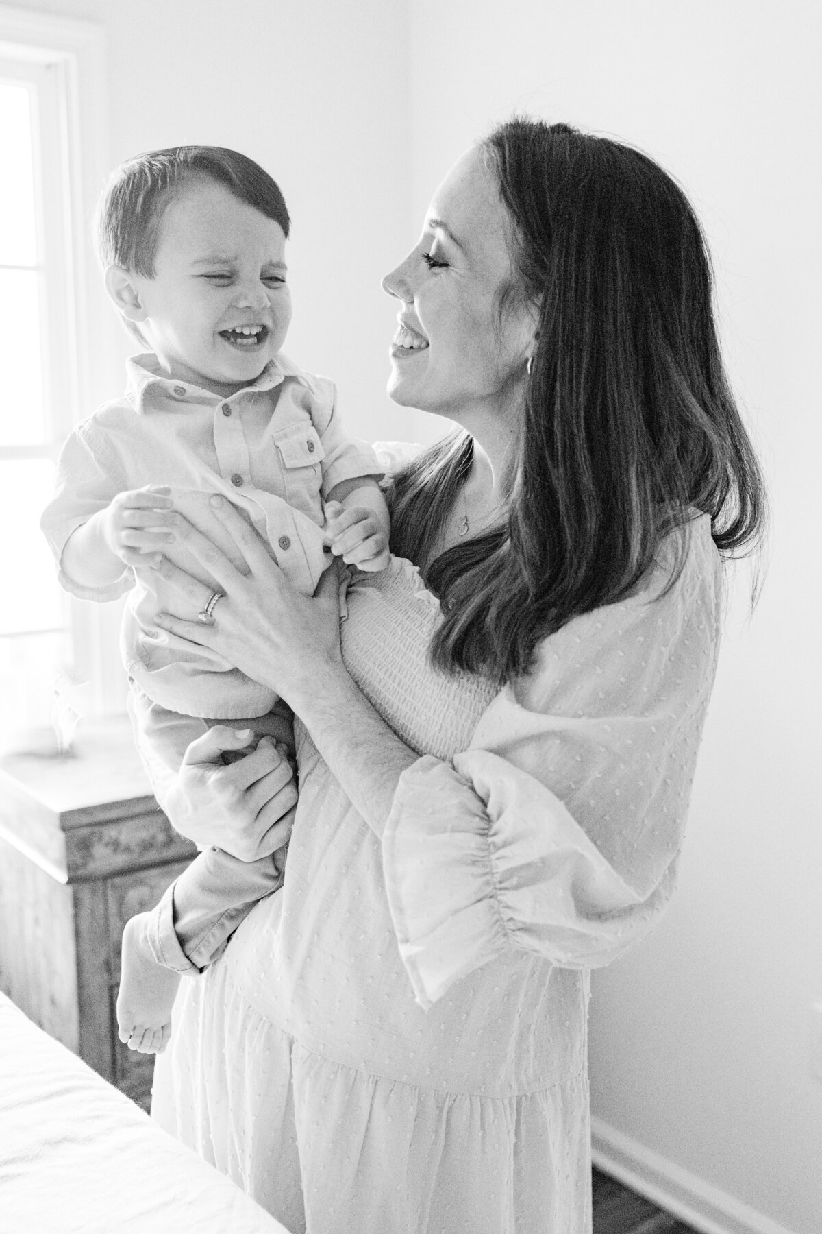 Mom tickling toddler son