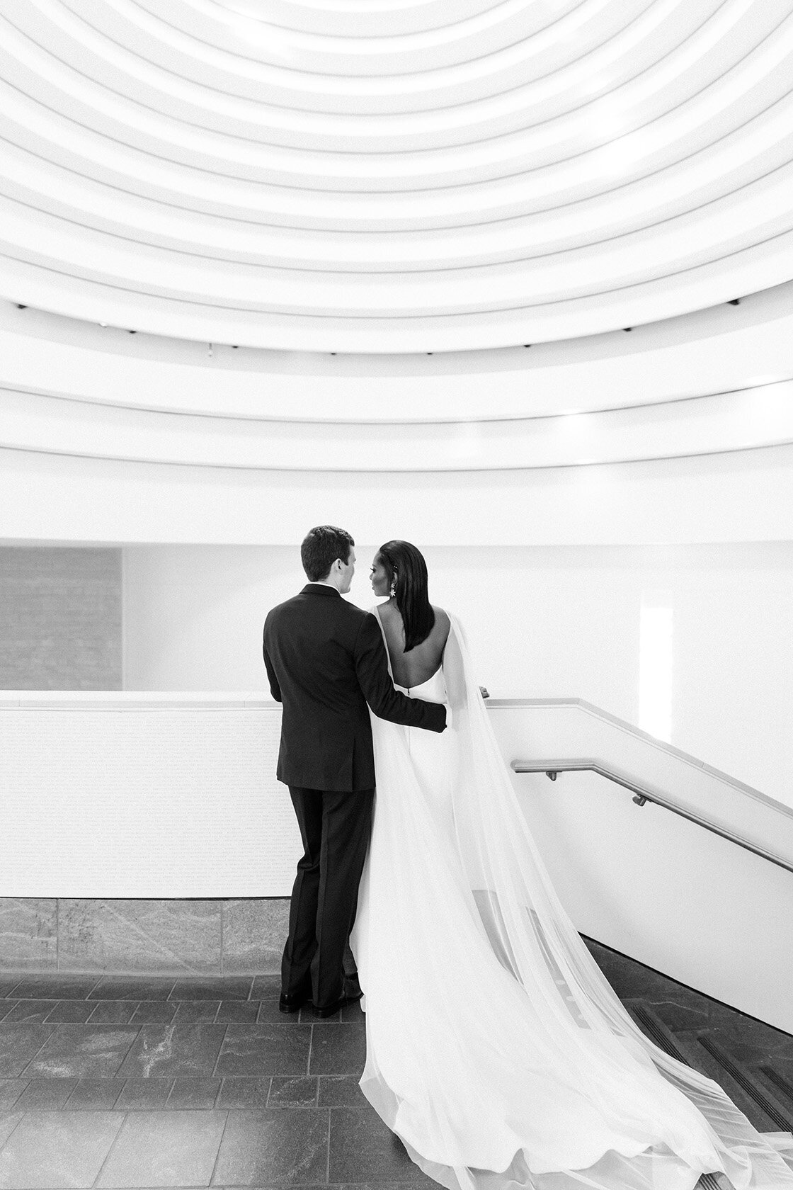 Bride & groom at National Museum of the Amercian Indian by Sarah Bradshaw