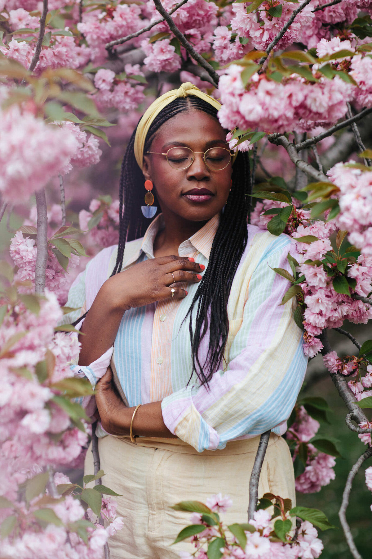 portrait of writer diana cenat surrounded by cherry blossoms