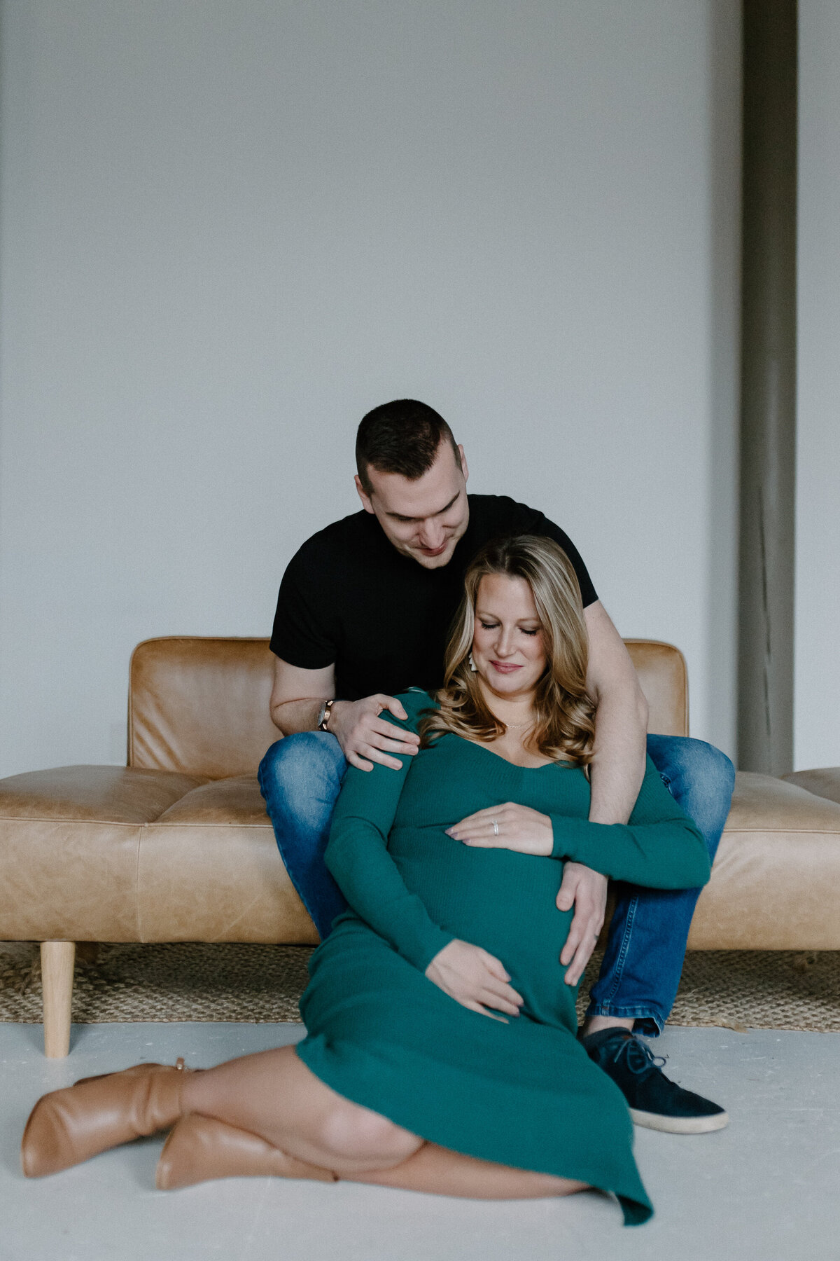 pregnant woman sitting with man on couch