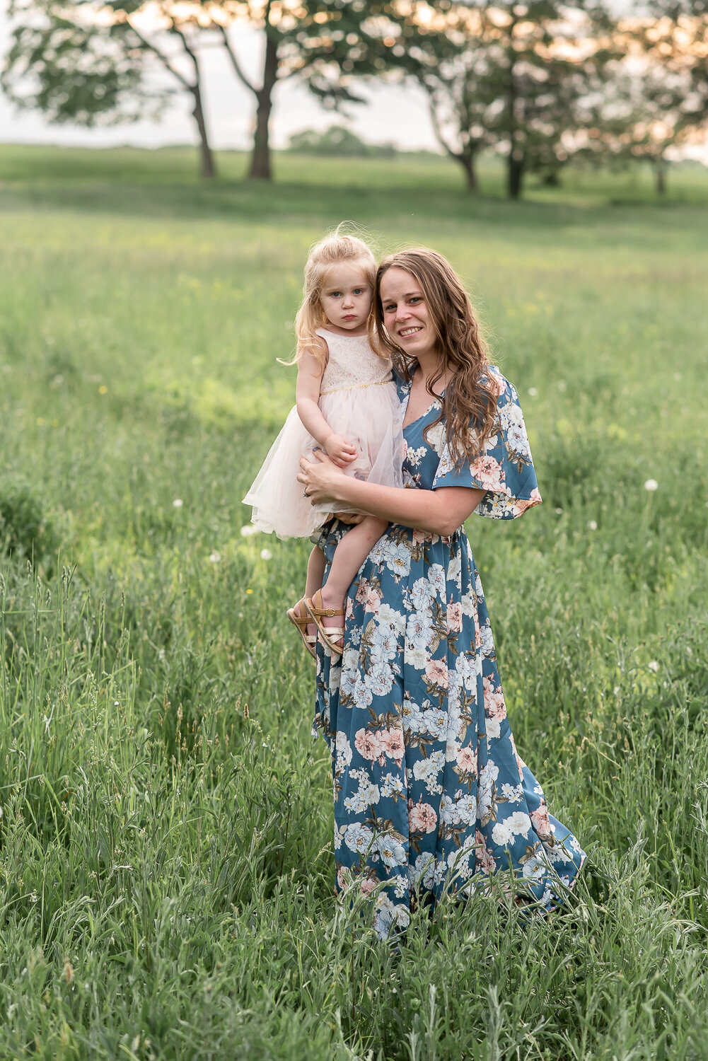 Mother and daughter smiling at camera in field at sunset |Sharon Leger Photography, Canton, Connecticut | CT Newborn and Family Photographer