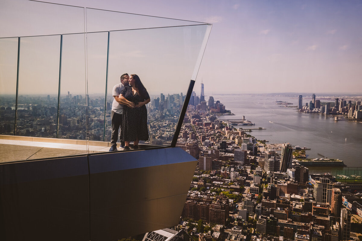 A couple standing at the viewing deck area at the Edge rooftop in nyc