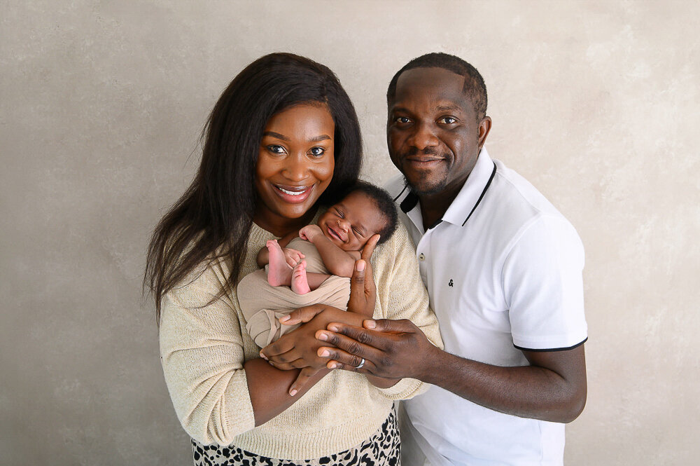 Mom and dad holding their newborn baby boy in Hamilton, Ontario.