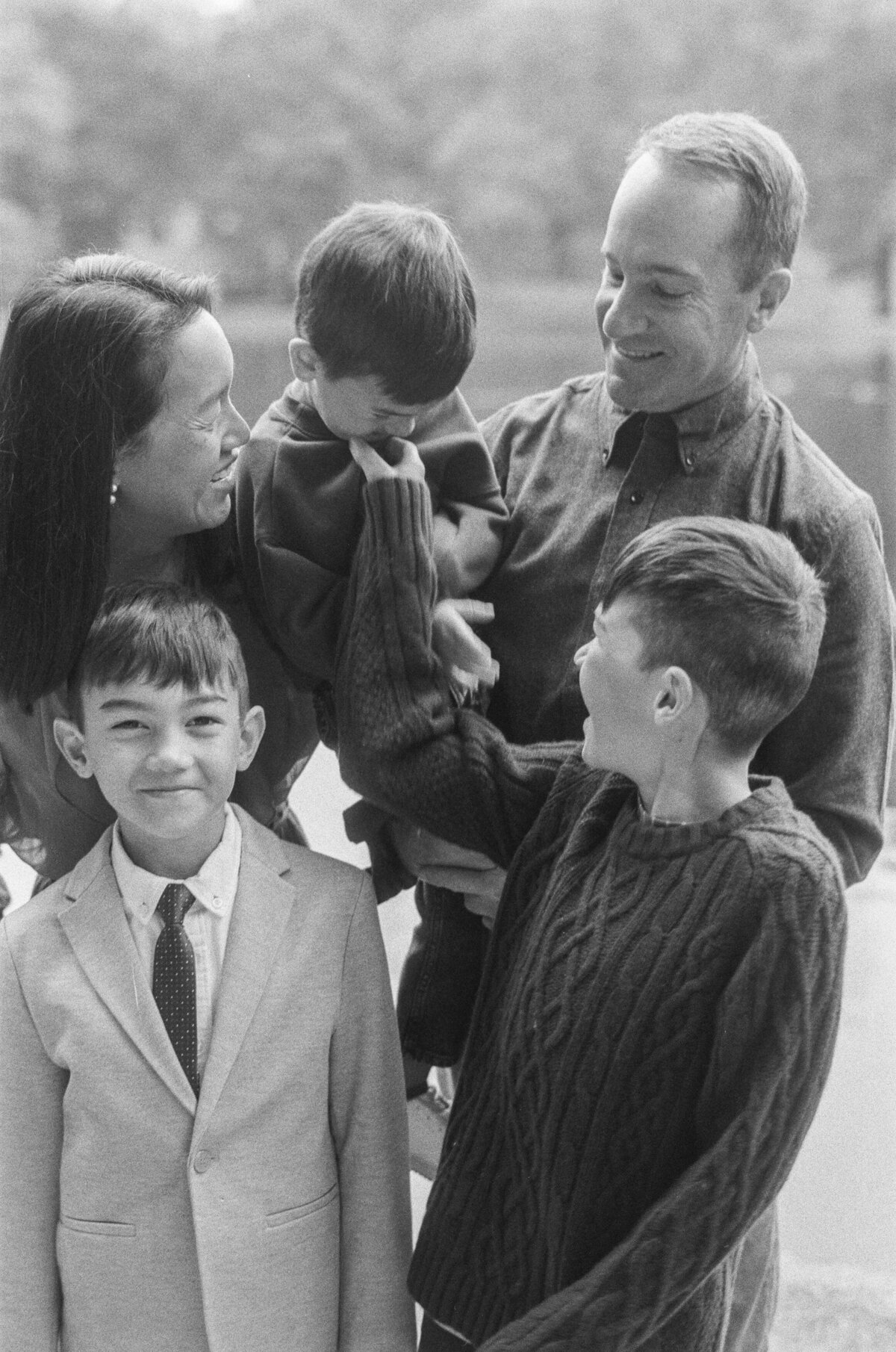 A candid photo of Kim-Trang and her family posing with each other