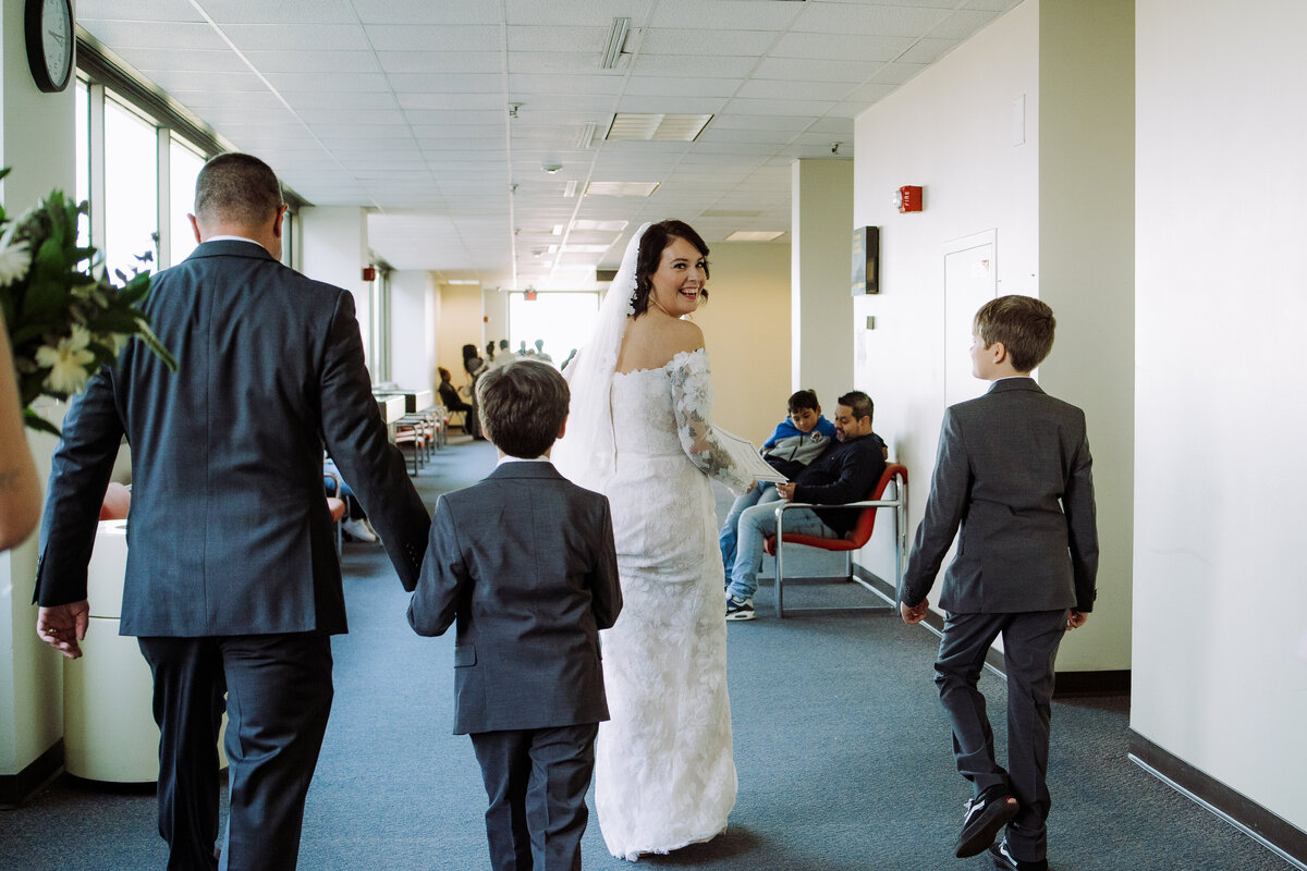 happy bride walking down hallway with guests