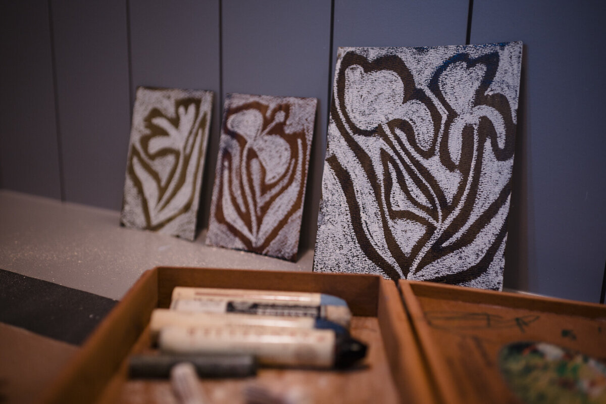 Close-up of colorful chalk art and materials in Texas artist's home studio during branding session.