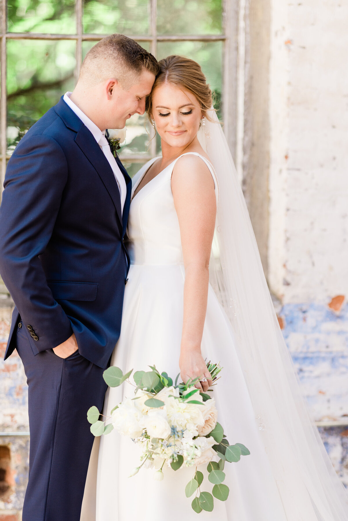 Bride and groom portrait on the patio of The Engine Room wedding venue, Monroe, GA
