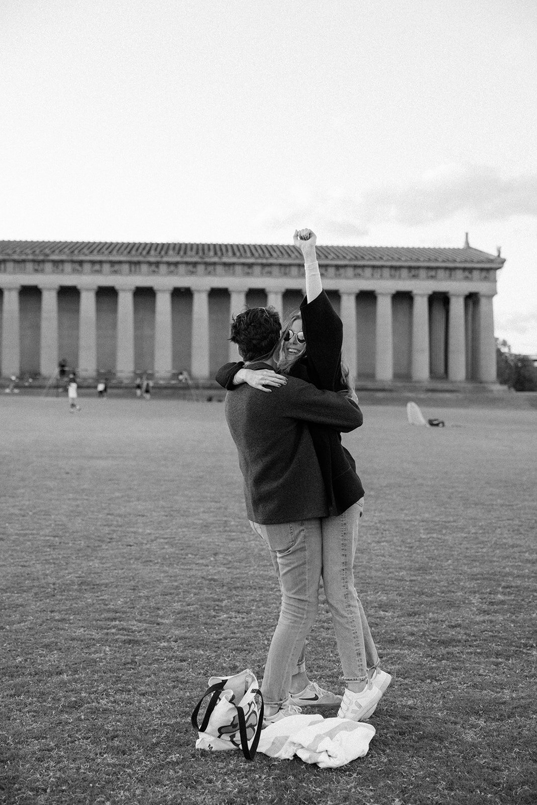 Girl pumps her fist in the air after her surprise proposal shot the Parthenon in downtown Nashville, TN.