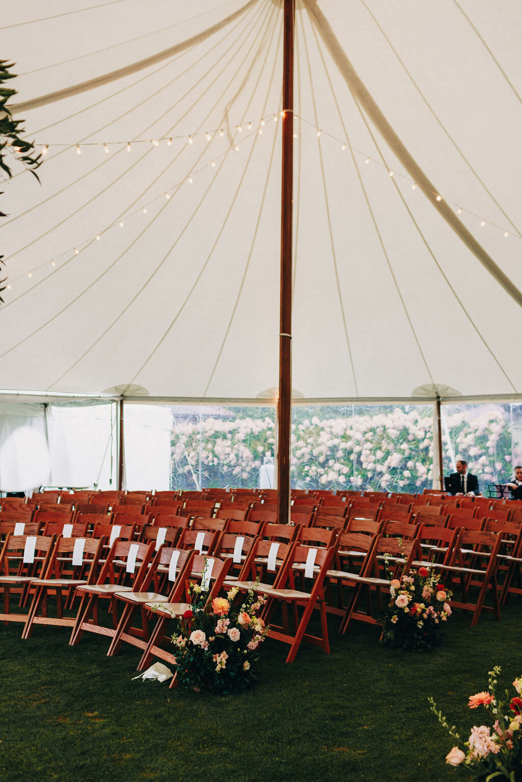 aisle-florals-string-lights-tented-wedding-ceremony