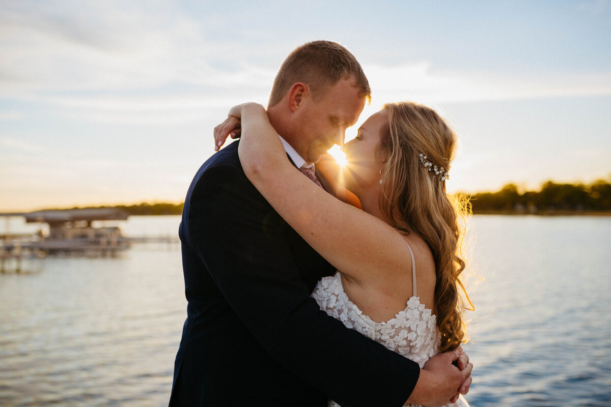 bride-and-groom-by-lake-at-sunset