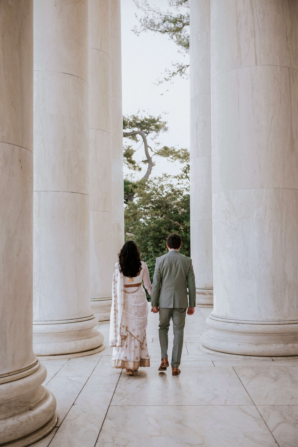 couple-holding-hands-marble-columns