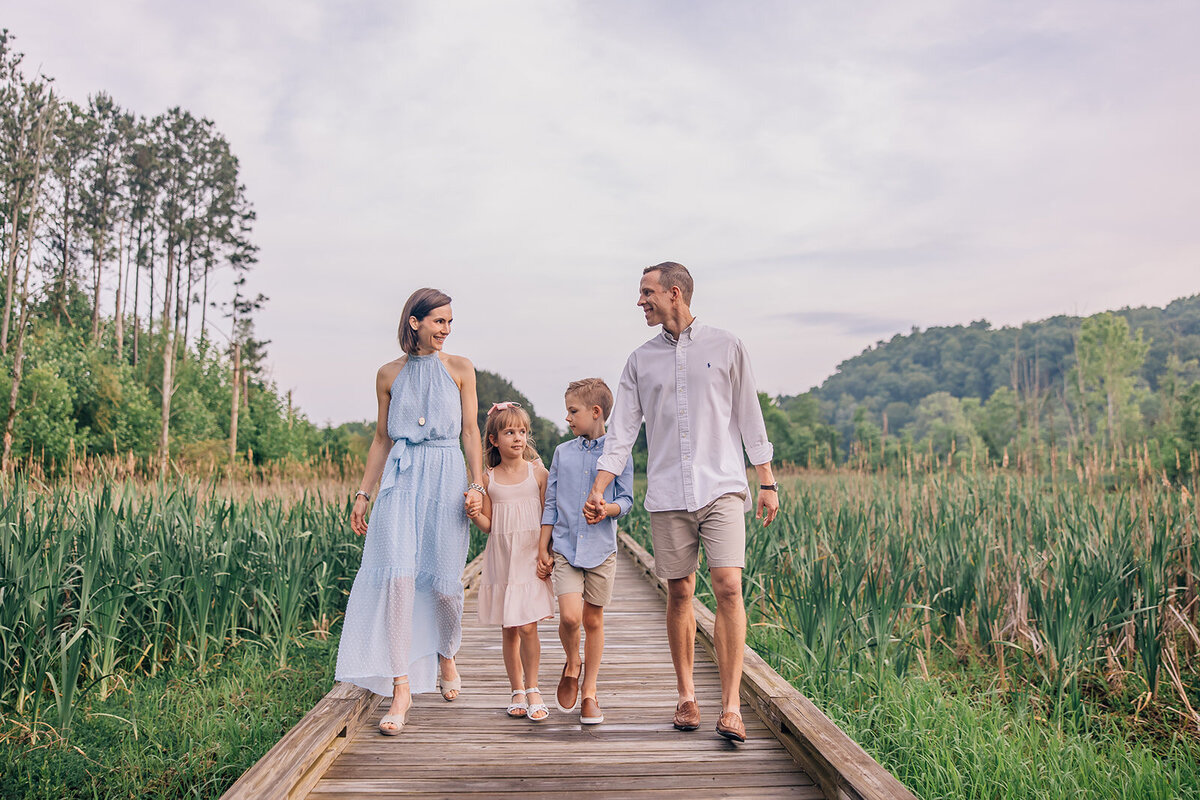 couple with 2 children walking holding hands