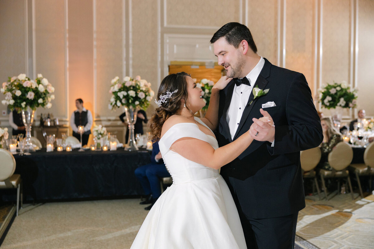 bride and groom sharing their first dance at The Adolphus in Dallas, capturing a romantic and elegant wedding moment on the dance floor.