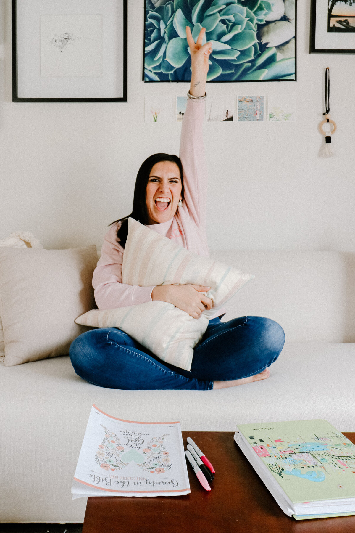 woman sitting on sofa with peace sign