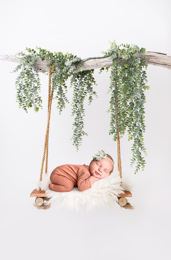 baby newborn on a swing photo