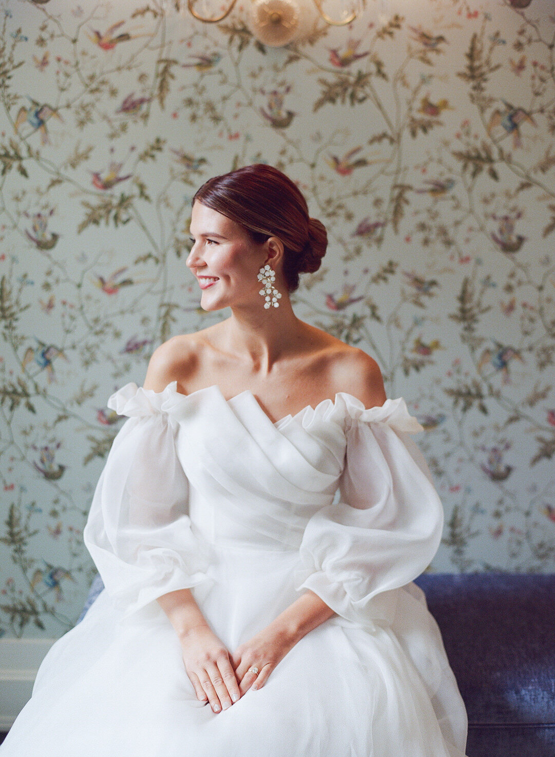 bride sitting with hands in her lap smiling