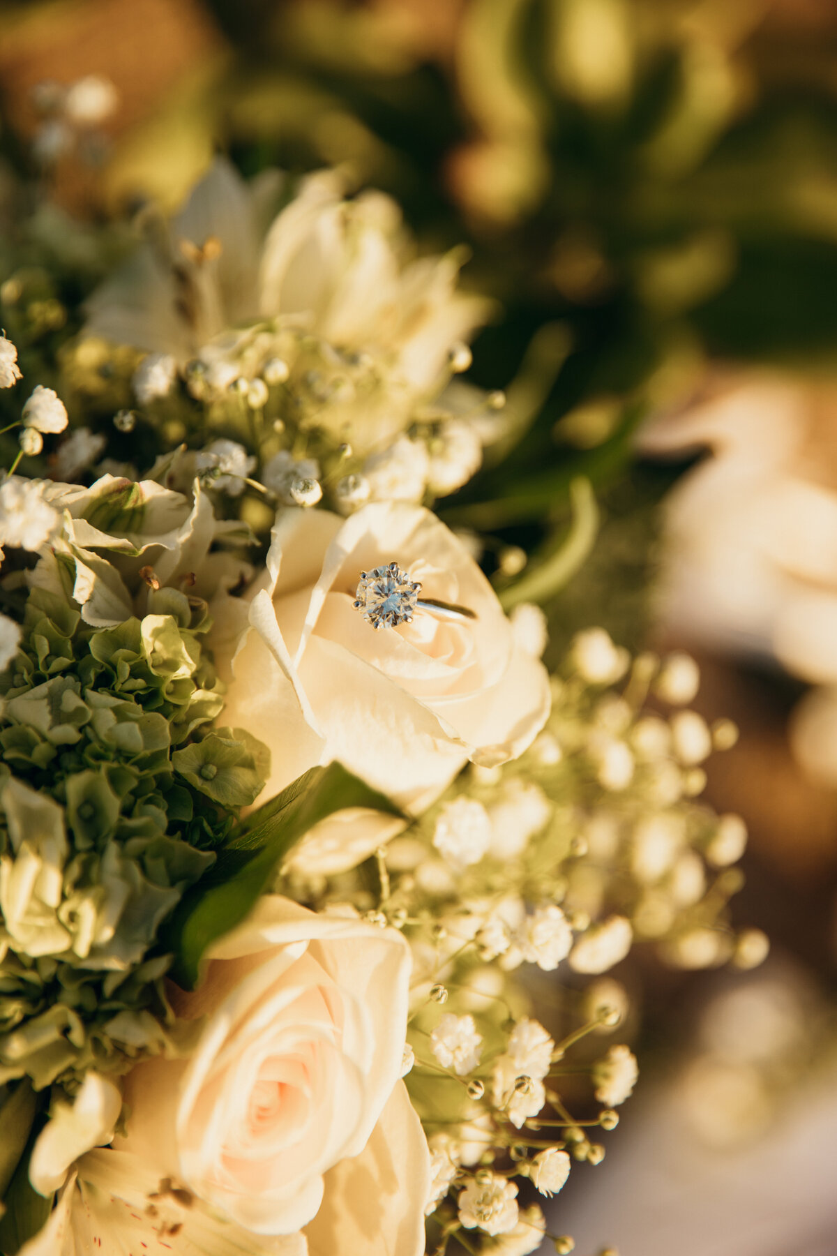 Maui Wedding Photographer captures white bridal bouquet with wedding ring in it