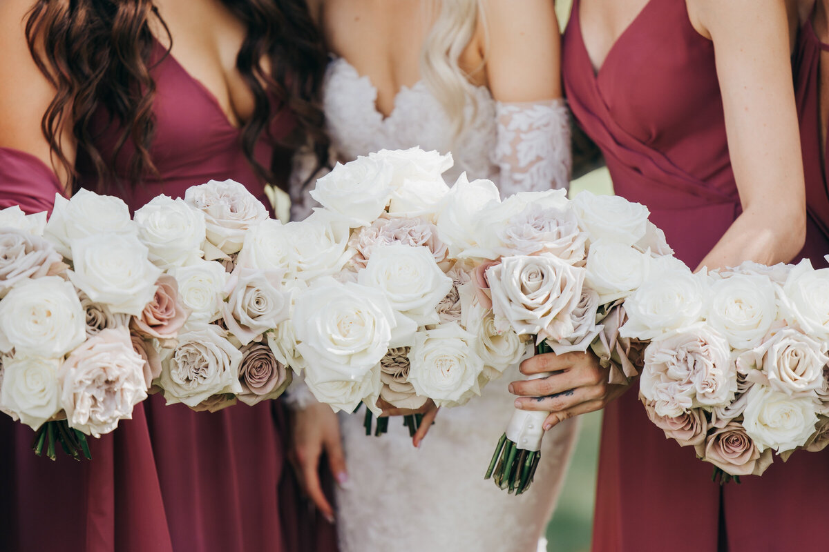 Glamorous detail photo of bride and bridesmaids white and pink rose bouquets