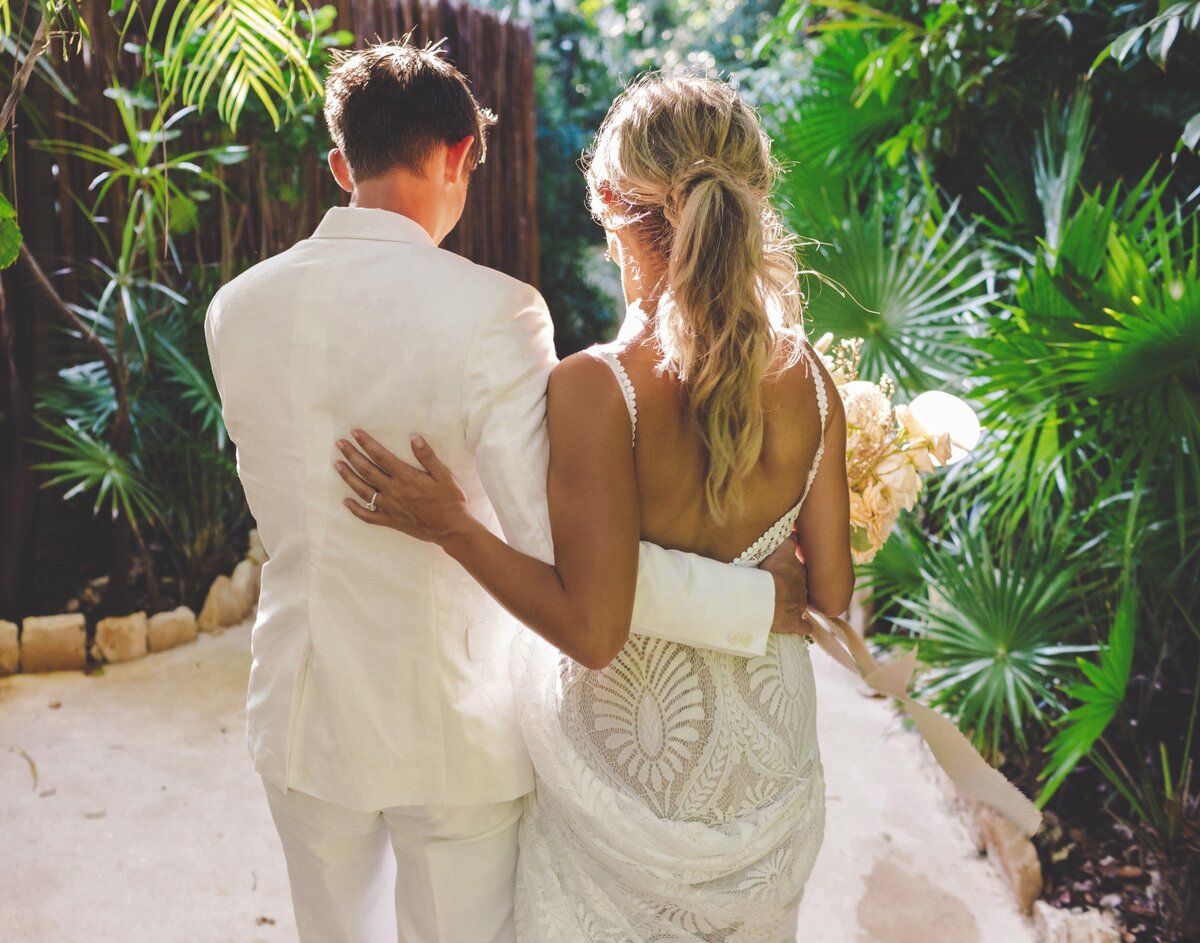 Bride and groom walking away at viceroy riviera maya wedding