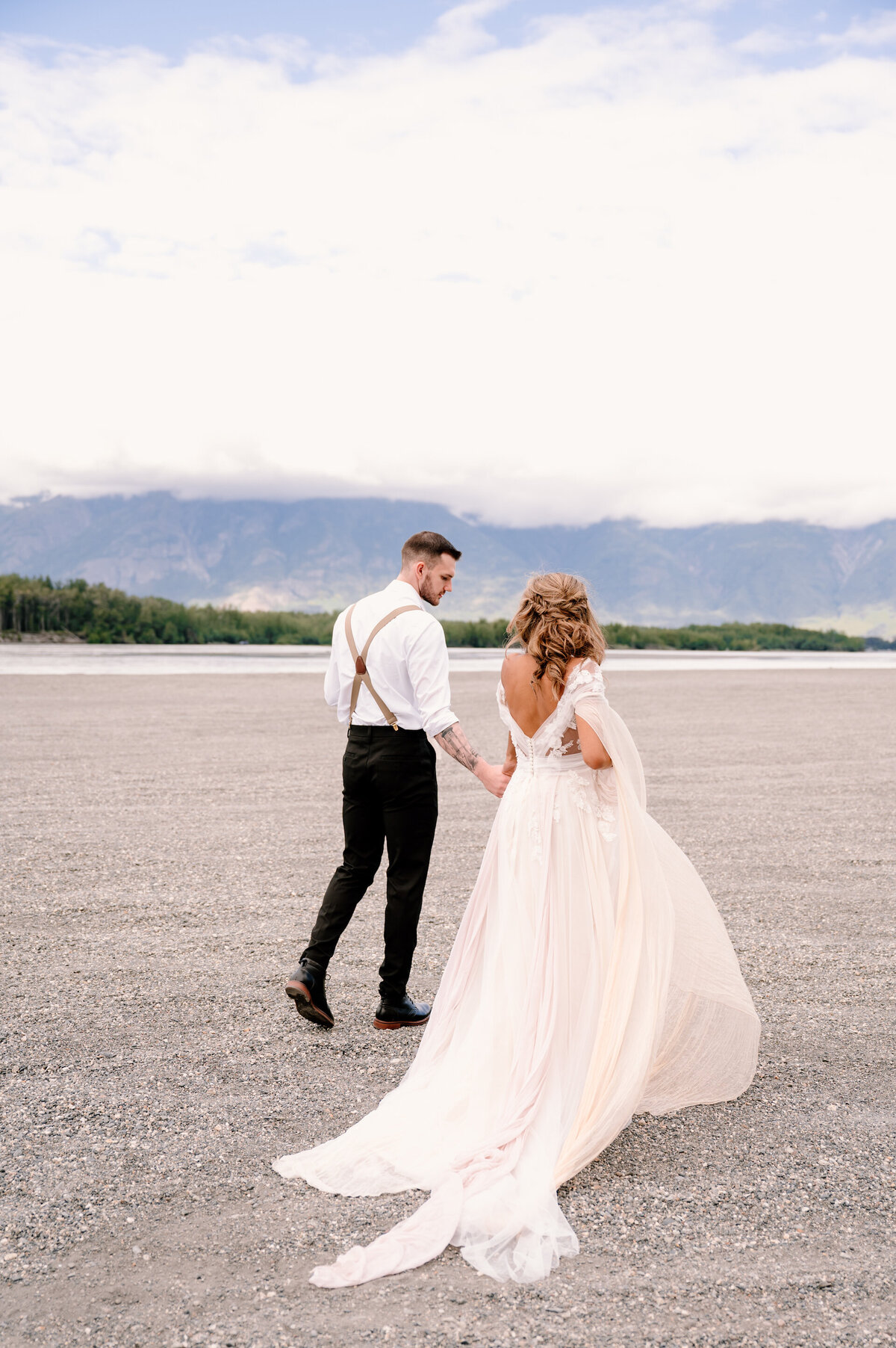 bride and groom walking on the beach