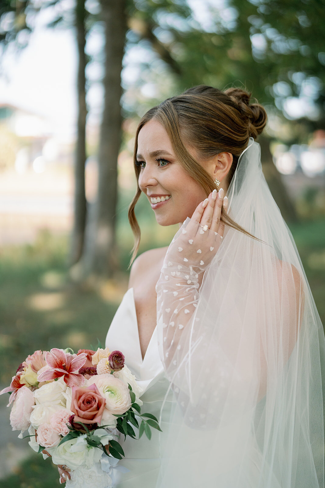 Close-up bridal portrait showing modern satin wedding dress taken at Boatwerks Waterfront wedding venue in Holland Michigan.