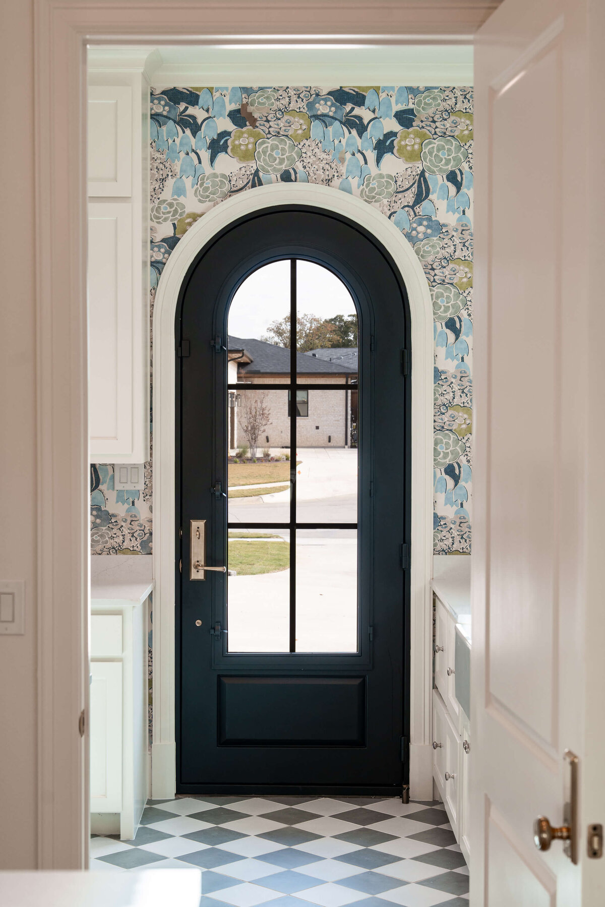 Arched door in whimsical custom home