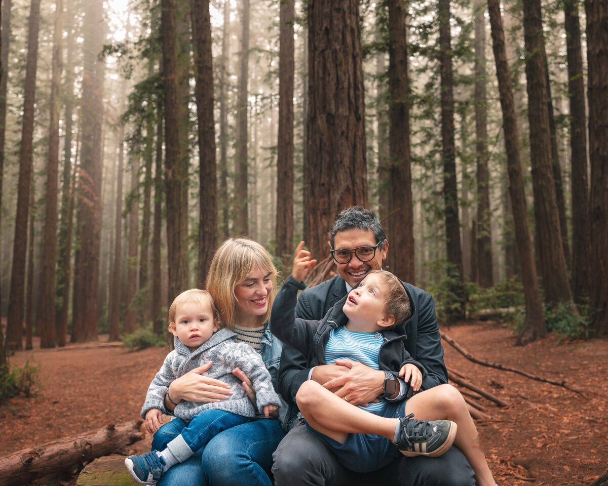 Parents and two children together in redwoods