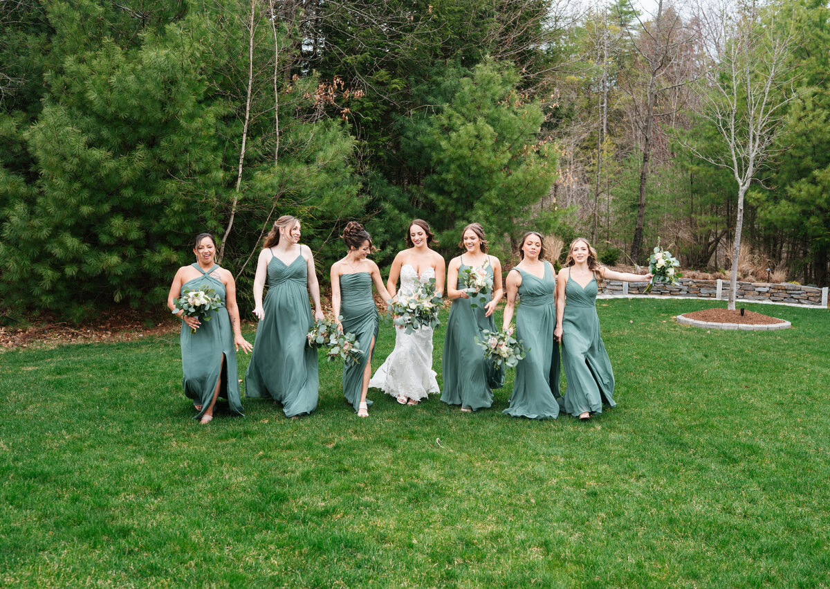 Bride and groom walking hand in hand at their outdoor New England wedding