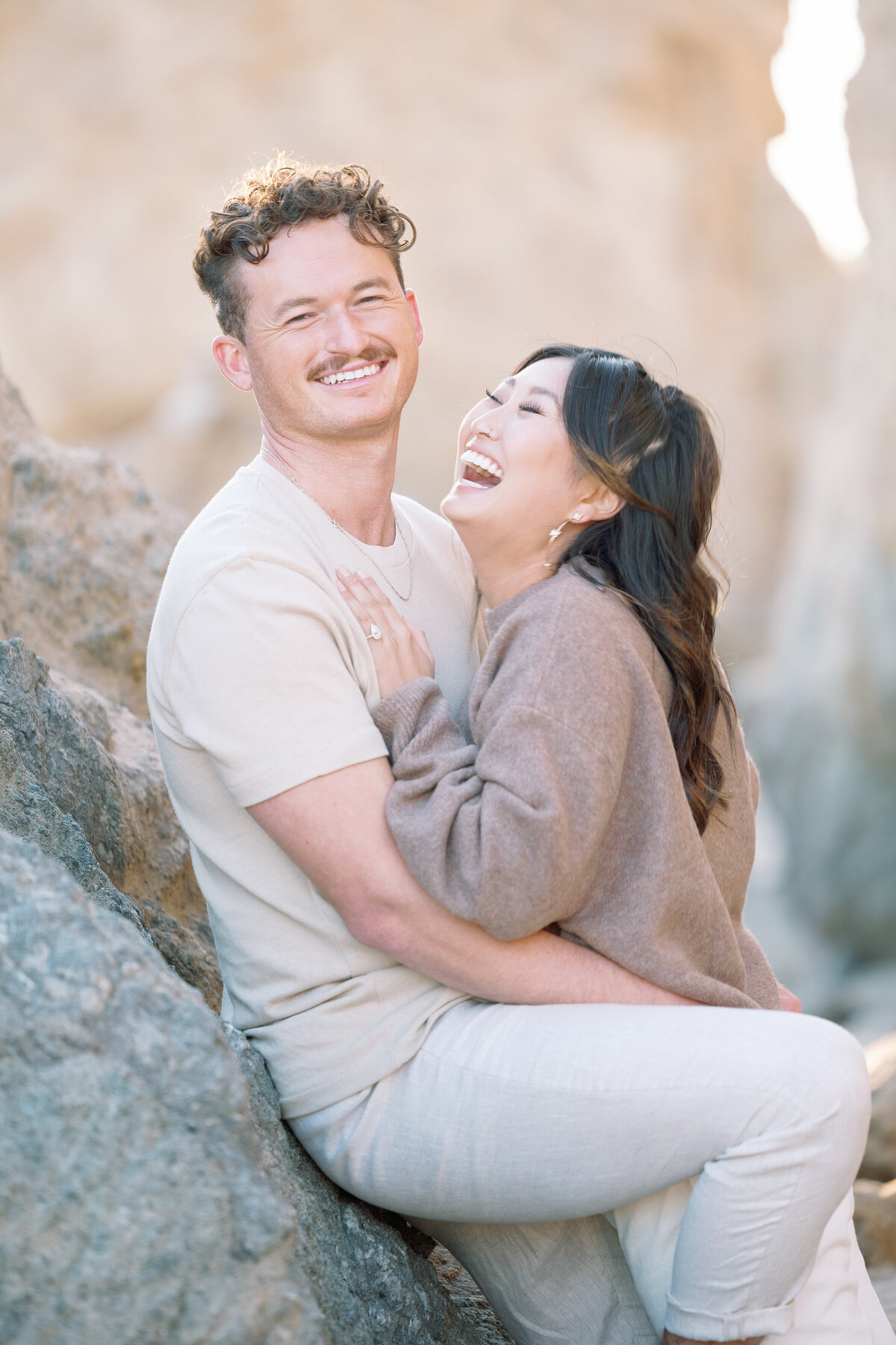 A couple standing close and laughing together