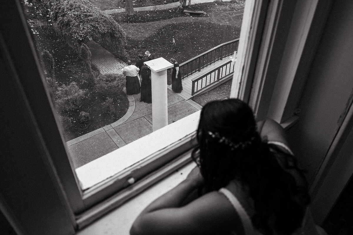 bride watches guests arrive  