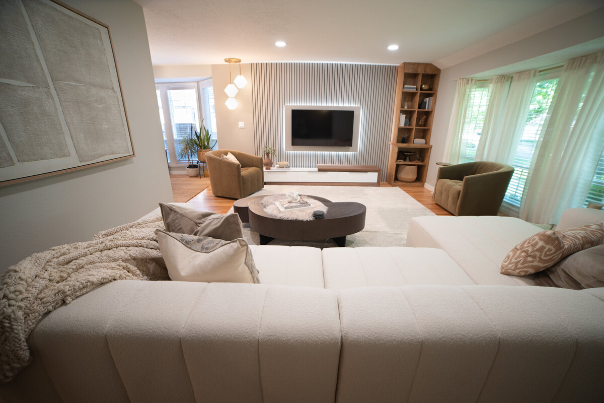 luxury great room with two white sofas fire place gold coffee table