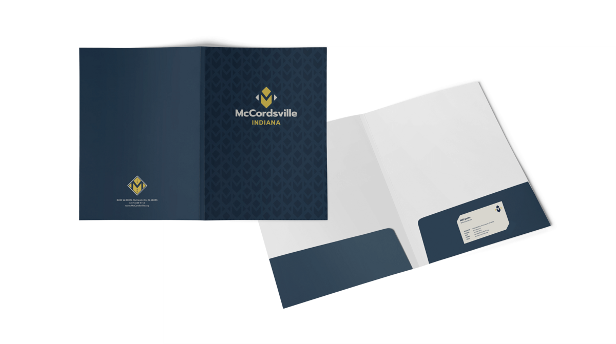 McCordsville folder design with brand pattern of diamonds and yellow logo on blue background