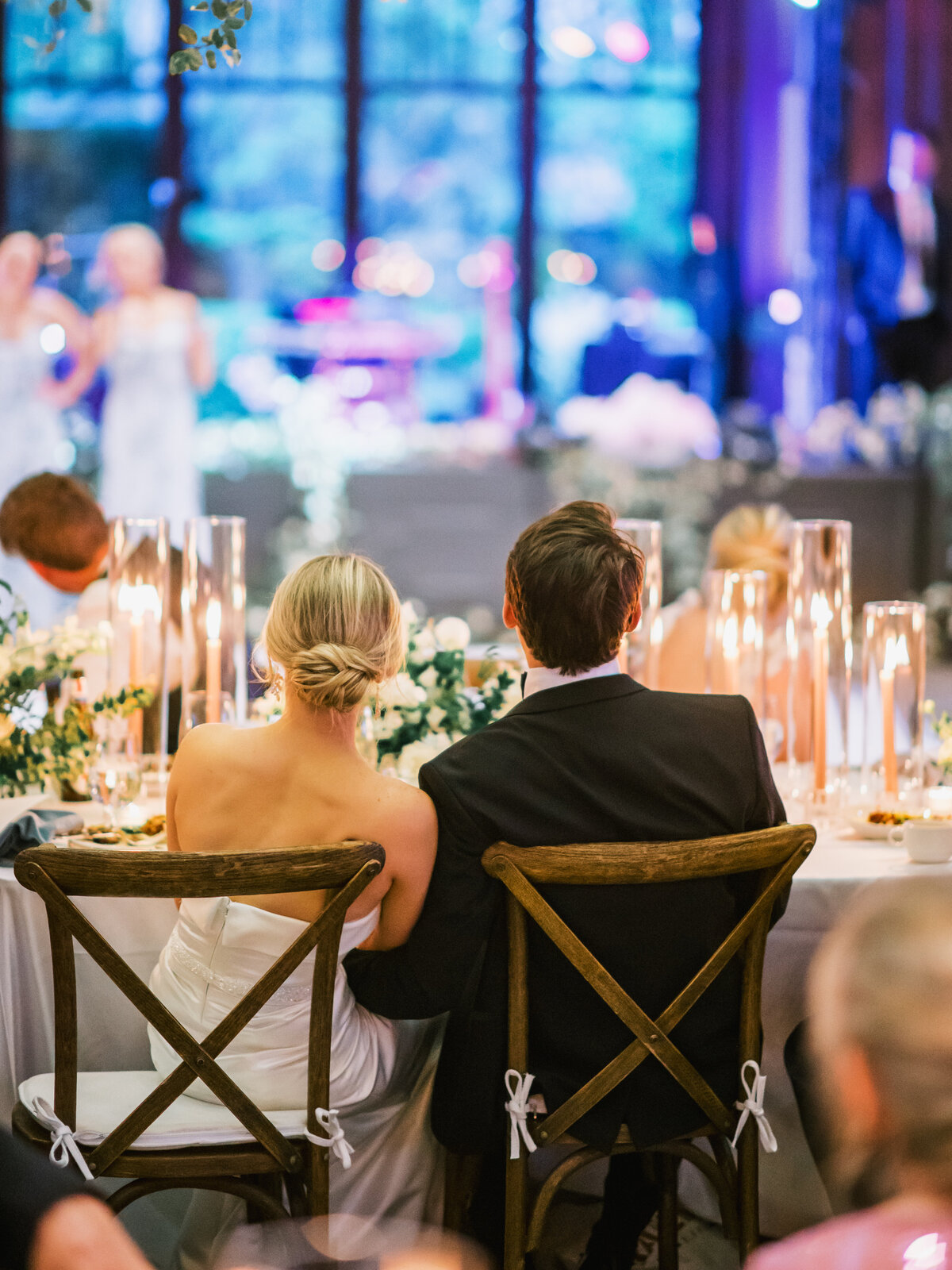 Bride and groom seated side by side during heartfelt wedding toasts at Old Edwards Inn in Highlands, North Carolina.