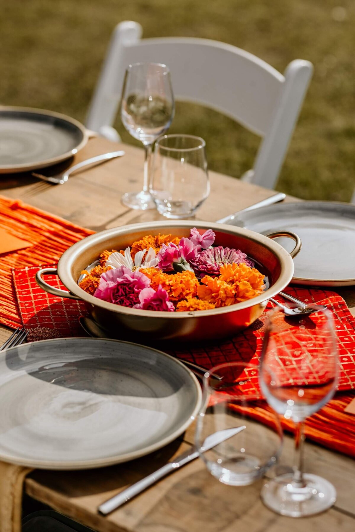 A colourful table setting for a lunch on the lawns