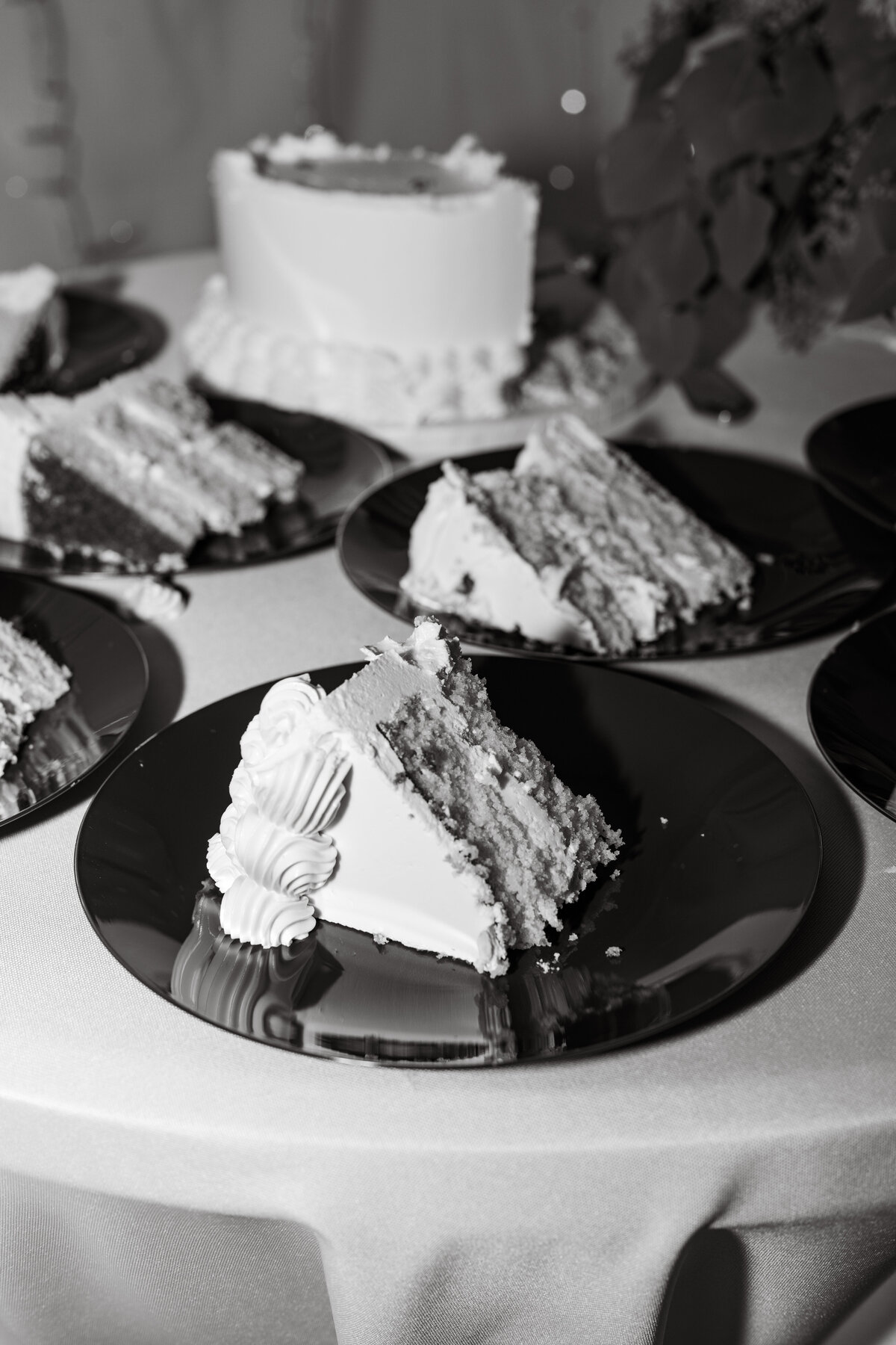 Wedding cake cut up and on a table taken by wedding photographers in Idaho.