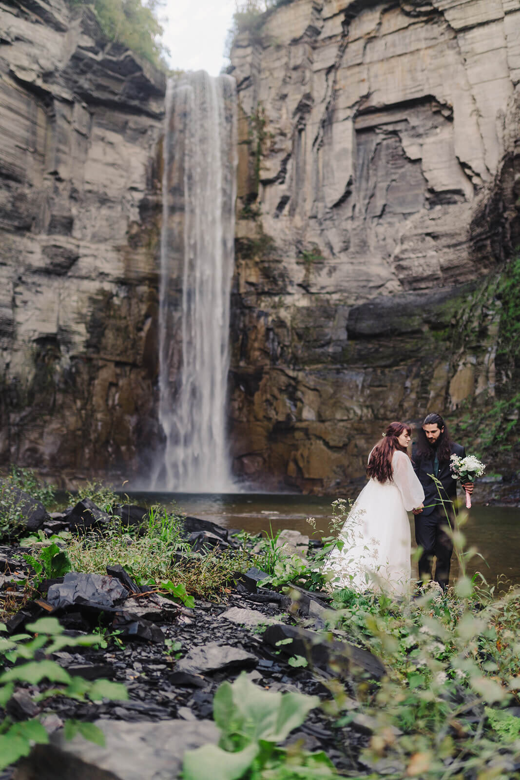 Bride and groom in front of waterfall at Finger Lakes wedding, NY