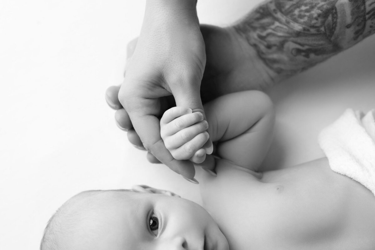 Newborn baby hand gripping finger detail Cedar Park lifestyle photographer