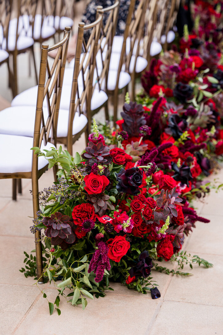 Beginning of aisle arrangements, red flowers, smoke, red roses, gold chairs, theme wedding  