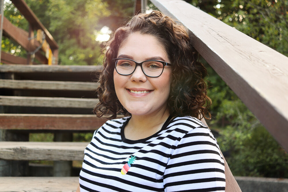 High school senior girl in Olympia WA smiling at Tumwater Falls