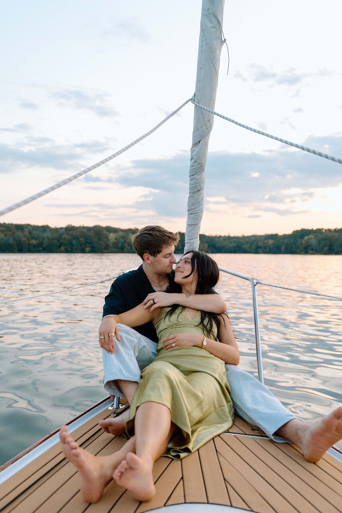 couple embracing each other at the front of a sail boat on percy priest lake in nashville