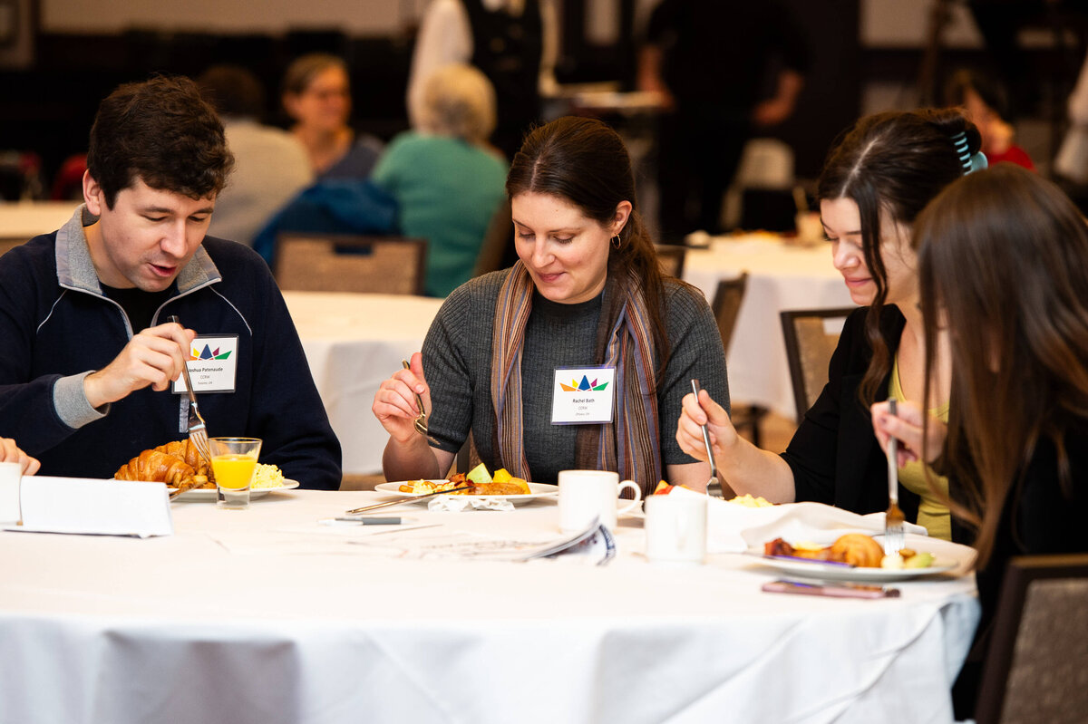 Ottawa event photography showing attendees eating breakfast during their corporate conference.  Captured by Ottawa Event Photographer JEMMAN Photography COMMERCIAL