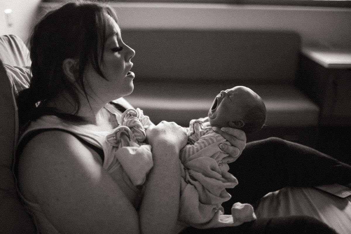 Newborn yawning while wrapped in swaddle during Nashville Fresh 48 session.