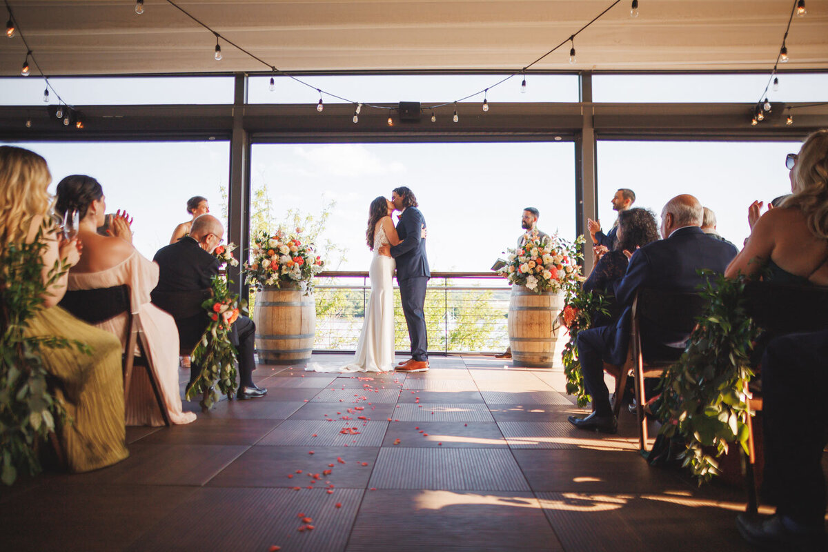 Bride and groom first kiss as a married couple