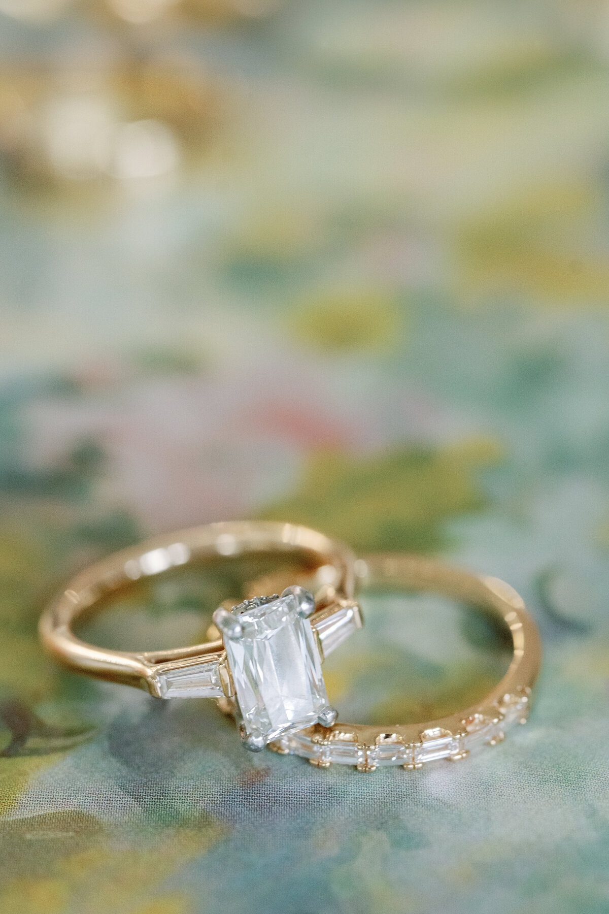 Brides rings agains colorful background by Springfield IL wedding photographer Lacey Graham